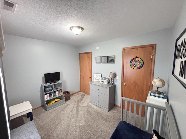 carpeted bedroom with a textured ceiling