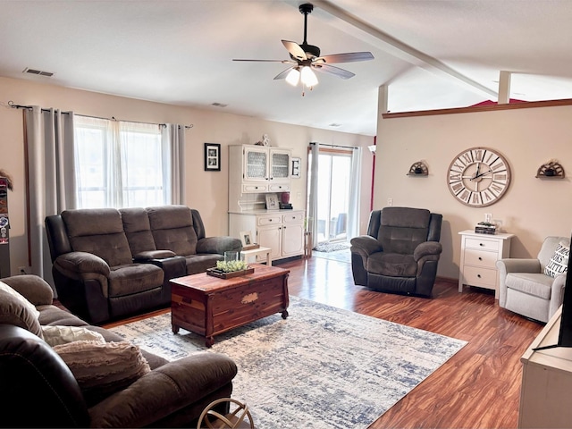 living room with dark hardwood / wood-style flooring, lofted ceiling with beams, and ceiling fan