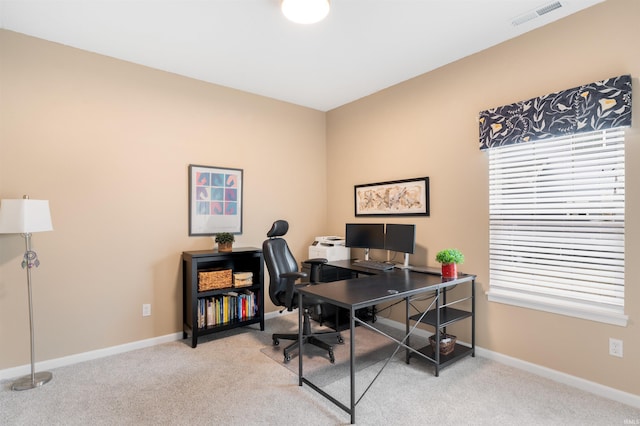 home office with a healthy amount of sunlight and light carpet