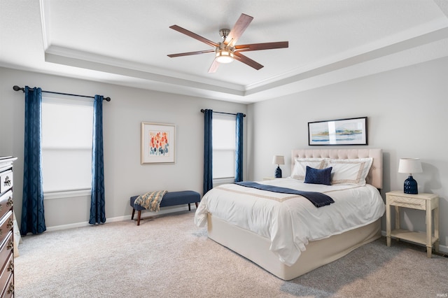 carpeted bedroom with crown molding, a raised ceiling, and ceiling fan