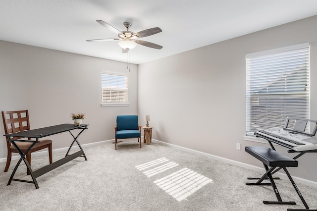 carpeted office space featuring ceiling fan