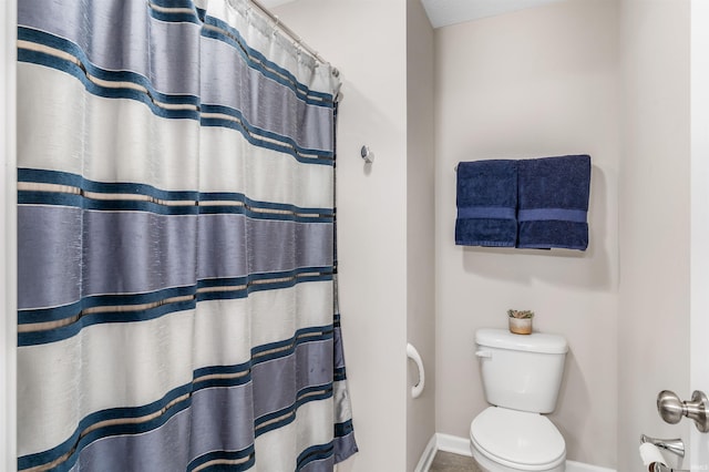 bathroom with walk in shower and toilet