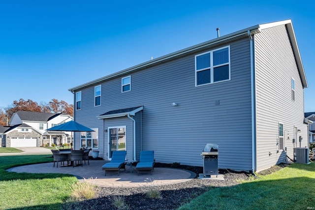 rear view of house featuring central AC, a patio, and a lawn