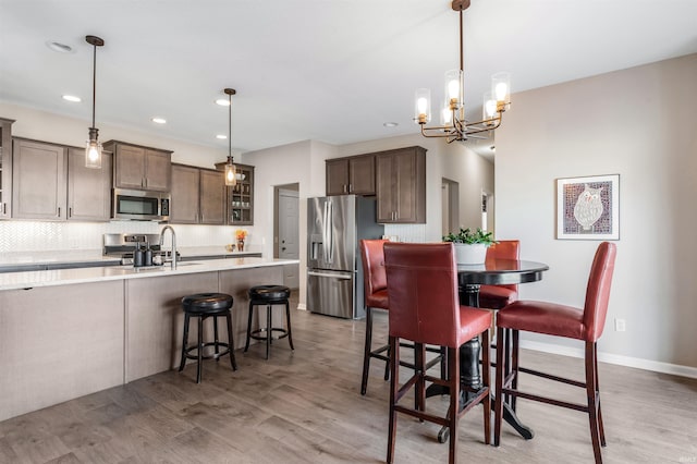 dining space featuring hardwood / wood-style flooring and sink