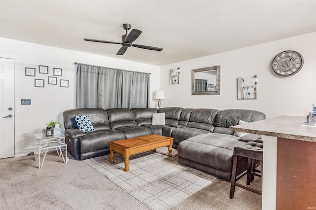 living room featuring a textured ceiling, light colored carpet, and ceiling fan