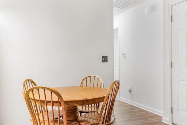 dining space featuring hardwood / wood-style flooring