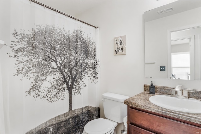 bathroom featuring vanity and toilet