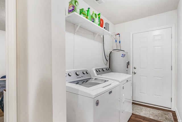 laundry area with independent washer and dryer, dark hardwood / wood-style floors, and electric water heater