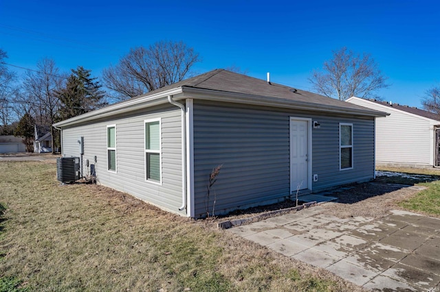 back of property featuring a yard, central air condition unit, and a patio area