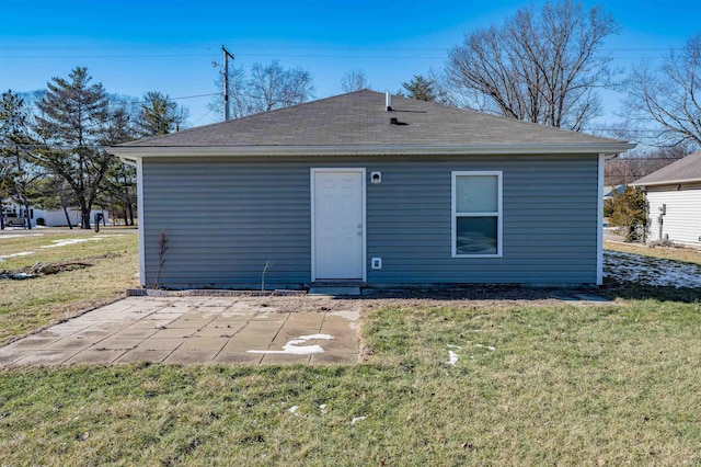 back of property with a yard and a patio