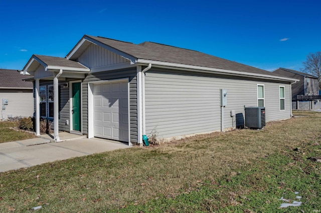 view of home's exterior with a garage, a lawn, and central air condition unit