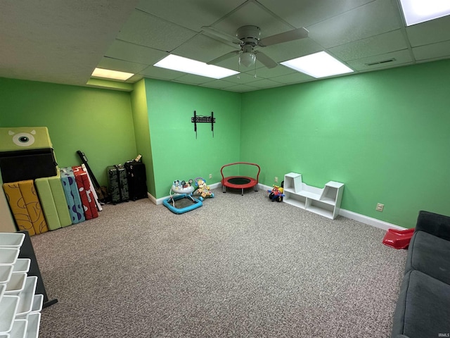 playroom featuring a drop ceiling, carpet floors, and ceiling fan