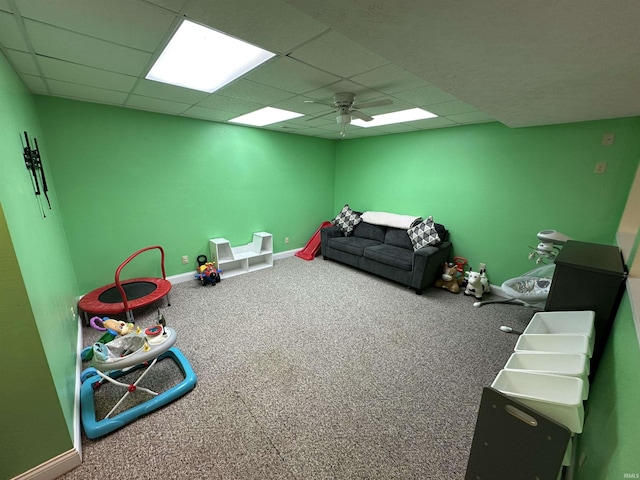 playroom with carpet flooring, a drop ceiling, and ceiling fan