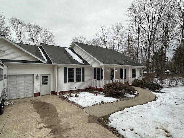 ranch-style home with a garage and covered porch