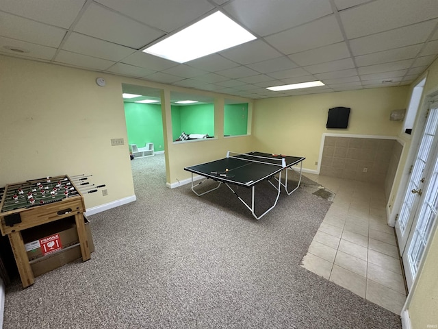 playroom with tile patterned flooring and a drop ceiling