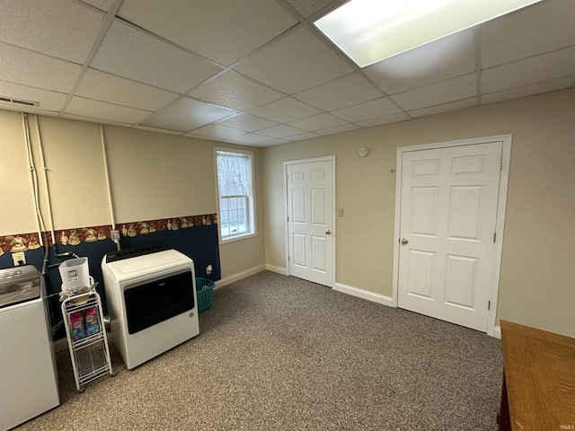 interior space with washer / clothes dryer and a drop ceiling