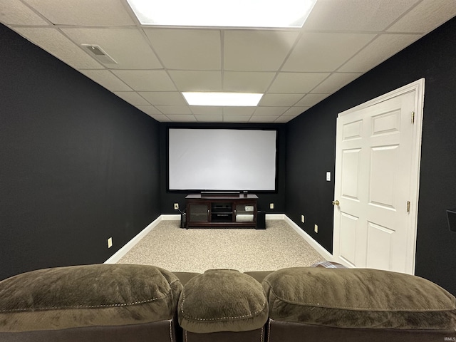 home theater room with a paneled ceiling and carpet floors