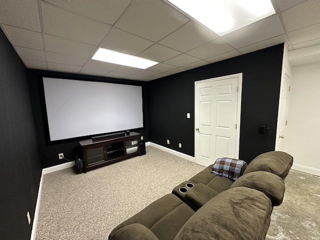 carpeted home theater room featuring a paneled ceiling