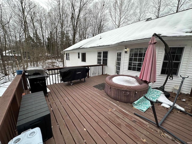 snow covered deck featuring a grill and a covered hot tub