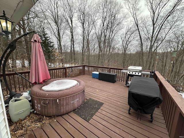 wooden deck featuring a hot tub and grilling area