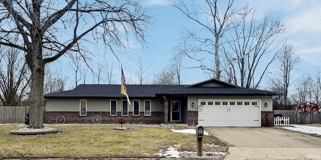 ranch-style home with a garage and a front lawn