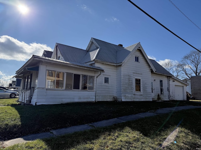 view of property exterior with a garage and a yard