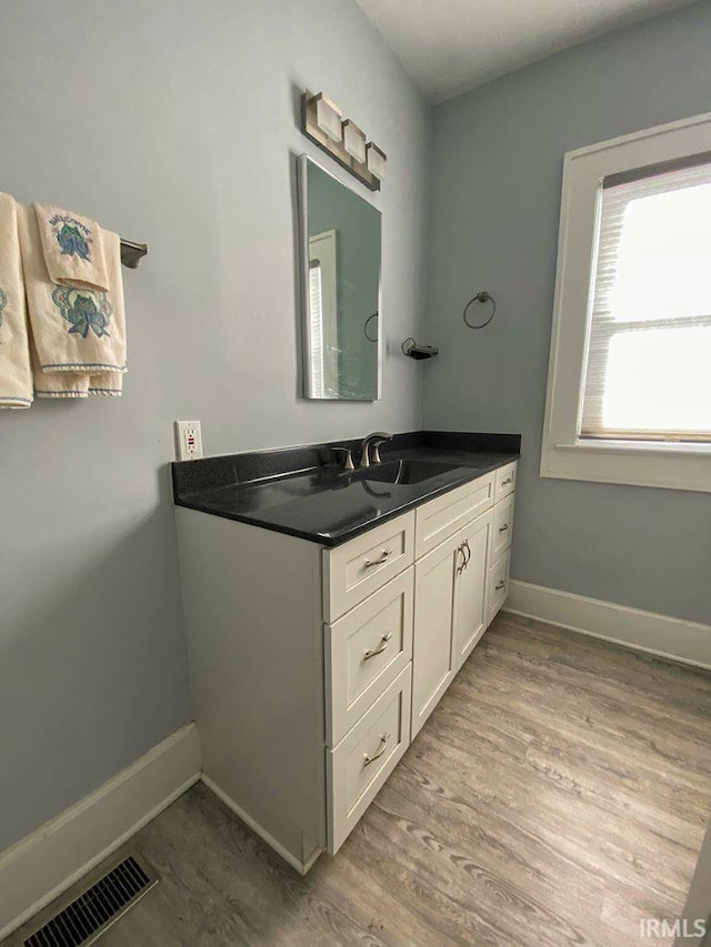 bathroom featuring hardwood / wood-style flooring and vanity