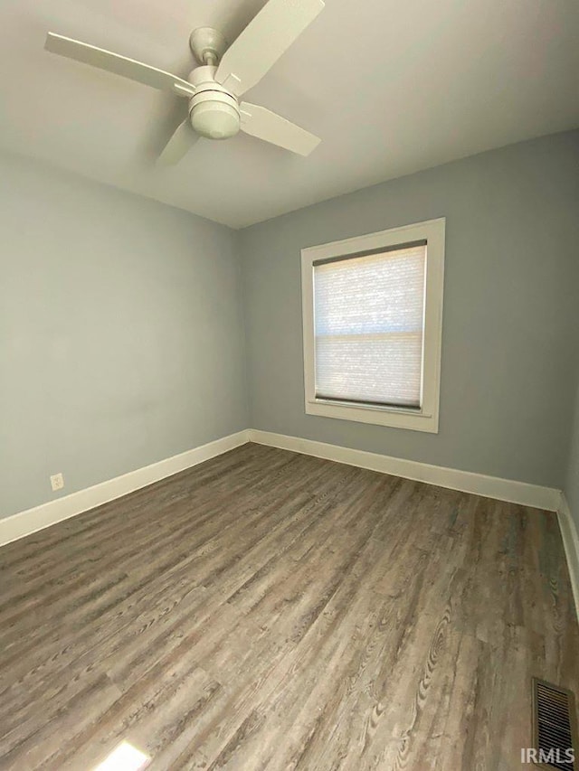 spare room with ceiling fan and wood-type flooring