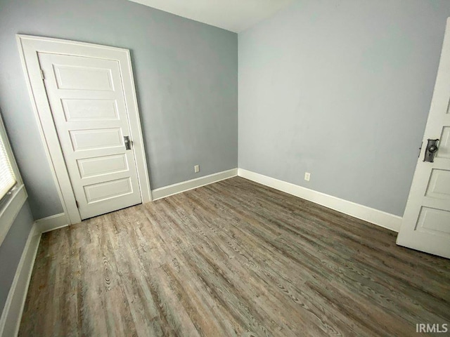 unfurnished room featuring dark wood-type flooring