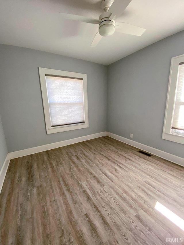 unfurnished room with ceiling fan and light wood-type flooring