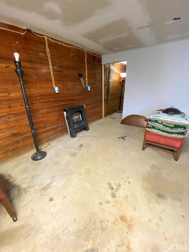 basement featuring wooden walls