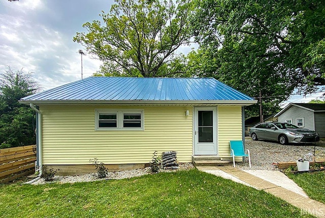 rear view of house featuring a lawn