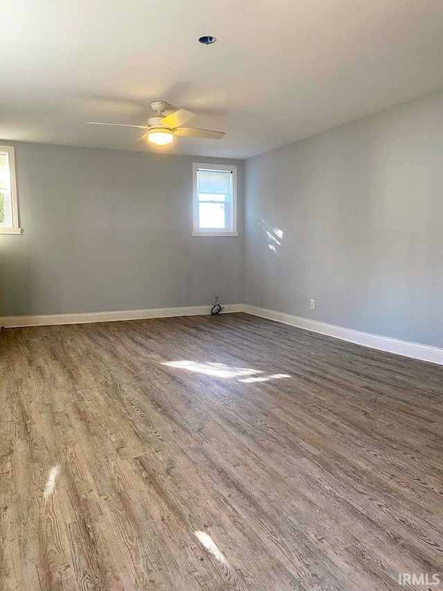 spare room featuring wood-type flooring and ceiling fan