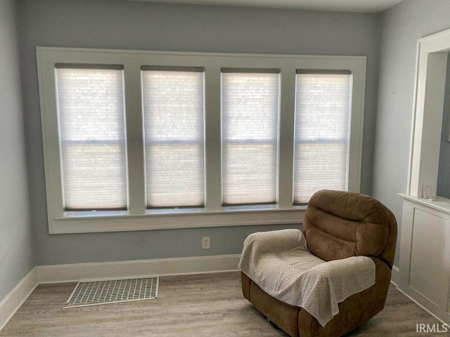 sitting room with a healthy amount of sunlight and light hardwood / wood-style floors