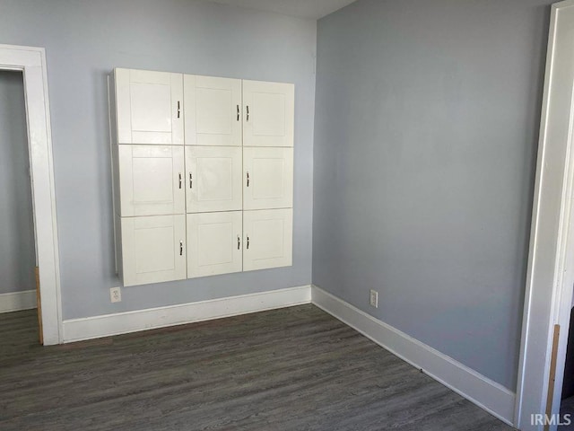 unfurnished bedroom with dark hardwood / wood-style floors