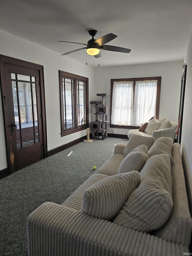 carpeted living room featuring ceiling fan and plenty of natural light