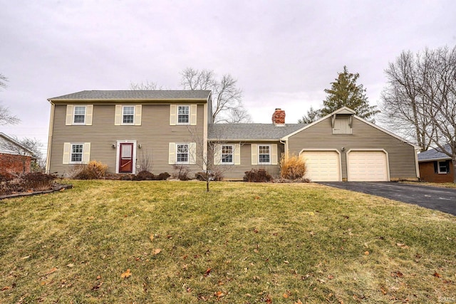 view of front of property with a garage and a front lawn