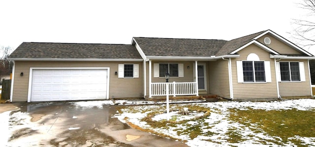 ranch-style home featuring a garage and covered porch