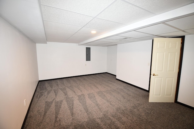 basement with electric panel, dark carpet, and a drop ceiling