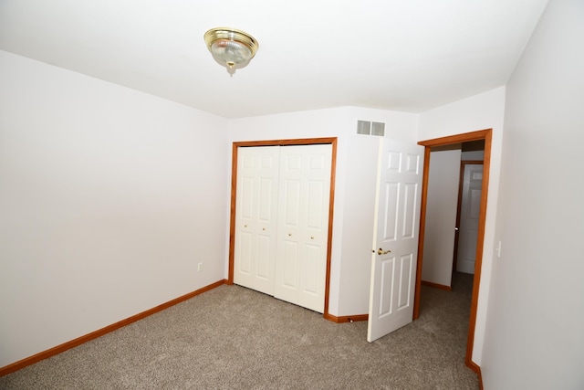 unfurnished bedroom featuring carpet flooring and a closet