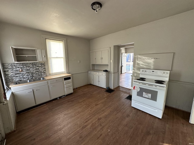 kitchen featuring white electric range oven, dark hardwood / wood-style flooring, sink, and white cabinets