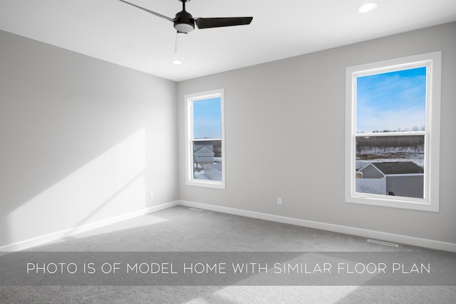 unfurnished room featuring carpet and ceiling fan