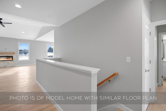 hallway featuring vaulted ceiling and light wood-type flooring