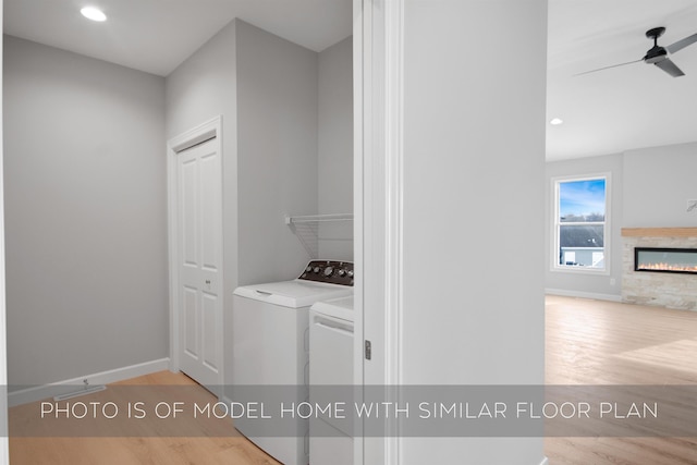 washroom with ceiling fan, light wood-type flooring, and washer and clothes dryer