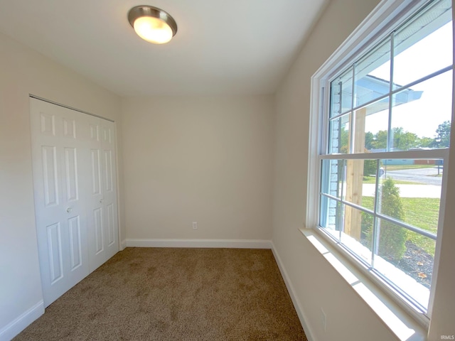 unfurnished bedroom with a closet and carpet flooring