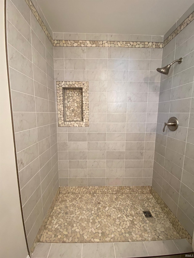 bathroom with tiled shower