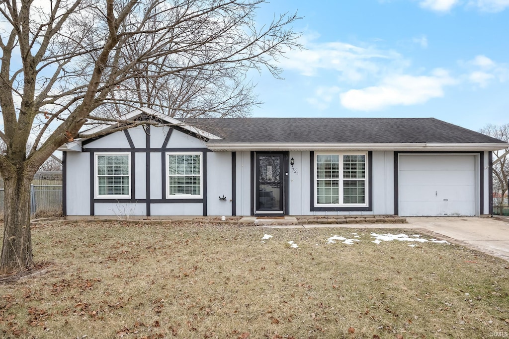 view of front of property with a garage and a front yard