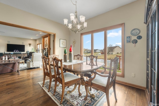 dining room with wood-type flooring and a chandelier