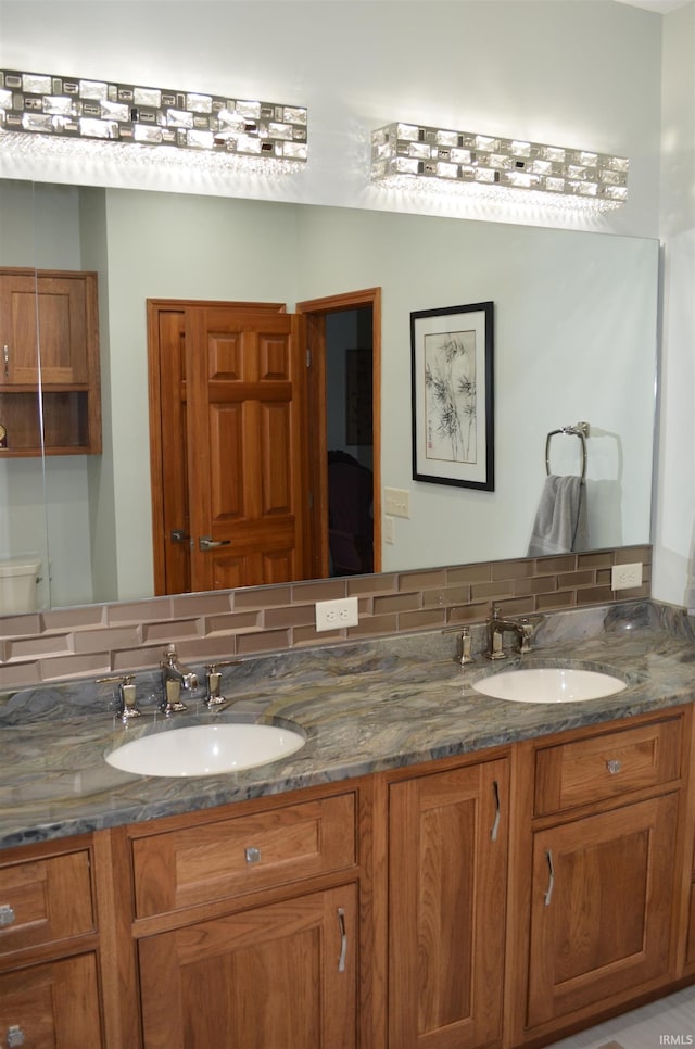 bathroom featuring vanity and backsplash