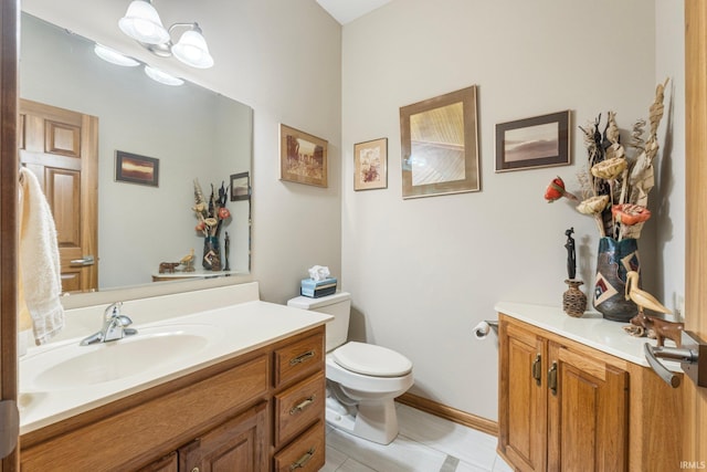 bathroom featuring vanity, tile patterned floors, and toilet